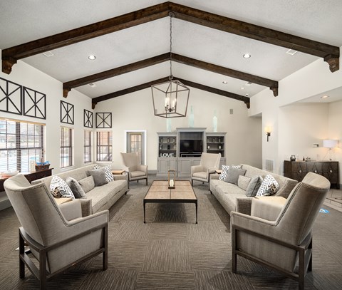 a large living room with couches and chairs and a table